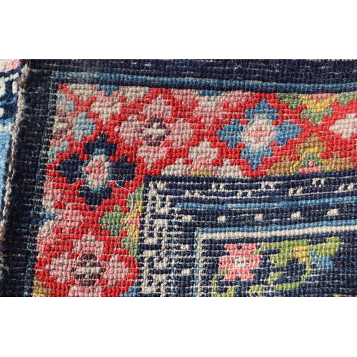 174 - A Tibetan saddle blanket; together with three Tibetan hand knotted meditation rugs, the largest 88 b... 