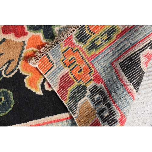 174 - A Tibetan saddle blanket; together with three Tibetan hand knotted meditation rugs, the largest 88 b... 