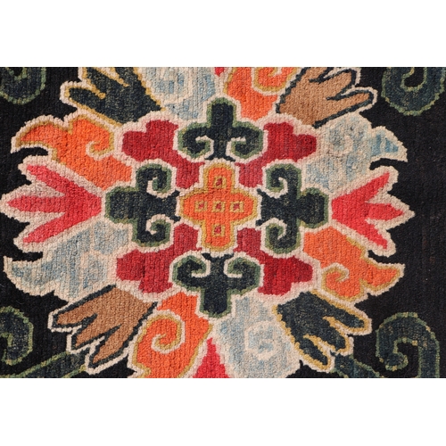 174 - A Tibetan saddle blanket; together with three Tibetan hand knotted meditation rugs, the largest 88 b... 