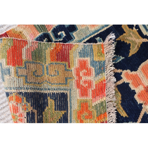 174 - A Tibetan saddle blanket; together with three Tibetan hand knotted meditation rugs, the largest 88 b... 