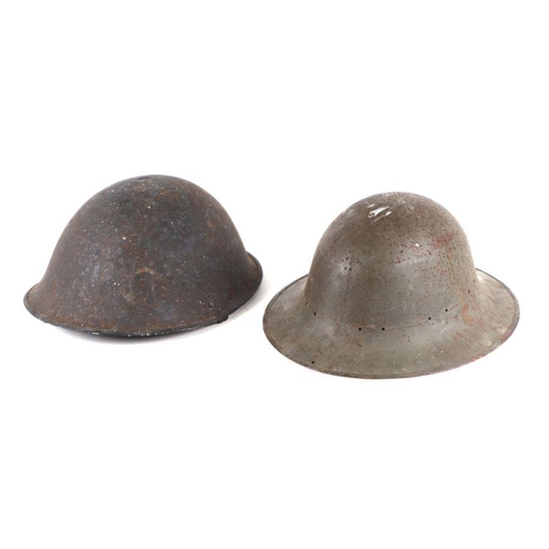 107 - A military helmet, stamped 'M Mor 3-41'; together with another military helmet (2).