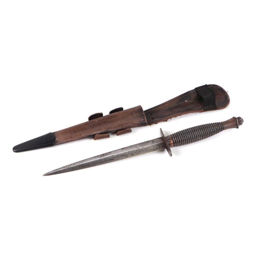 113 - A Fairbairn Sykes style fighting knife with leather scabbard, 30cms long.