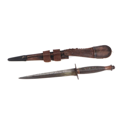 113 - A Fairbairn Sykes style fighting knife with leather scabbard, 30cms long.