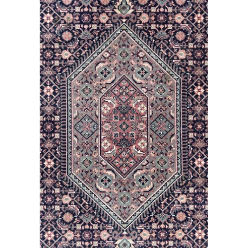 133 - A Persian Kashan rug with geometric design on a pink ground, 170 by 237cms.