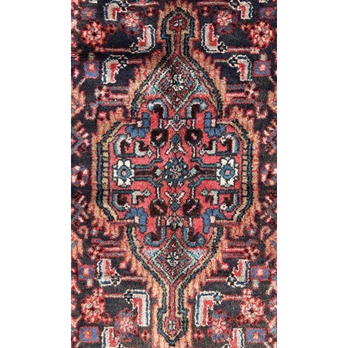 140 - A Persian Hamadan runner on a red ground, 280 by 80cms (333).