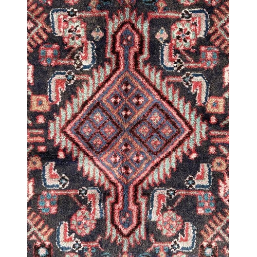 140 - A Persian Hamadan runner on a red ground, 280 by 80cms (333).