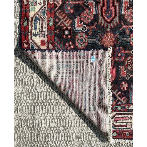 140 - A Persian Hamadan runner on a red ground, 280 by 80cms (333).