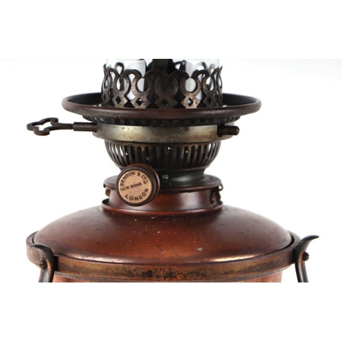 330 - A Benson & Co Arts & Crafts brass and copper oil lamp with copper reservoir within a brass cage, on ... 