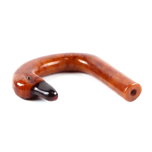 351 - An early plastic amber like walking stick handle in the form of a duck with a cherry amber Bakelite ... 