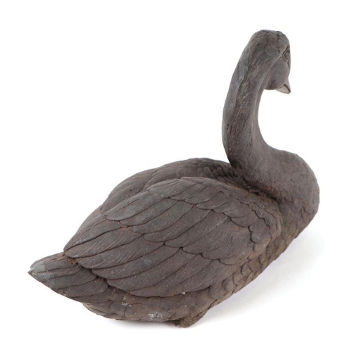 380 - A patinated bronze figure of a seated goose, 29cms long.