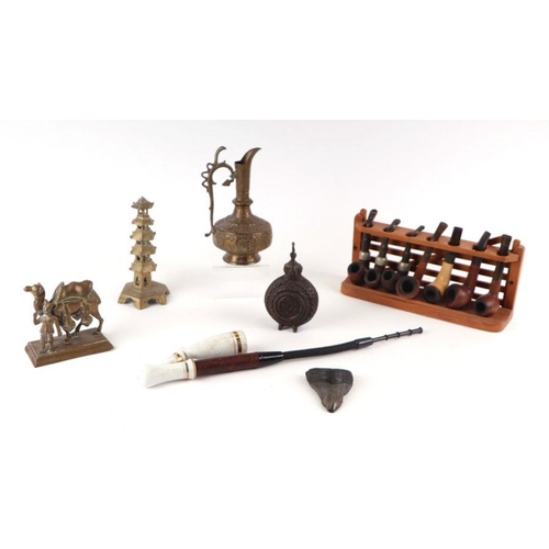 385 - A quantity of assorted smokers items to include a collection of Brier type pipes, on a pipe rack, a ... 