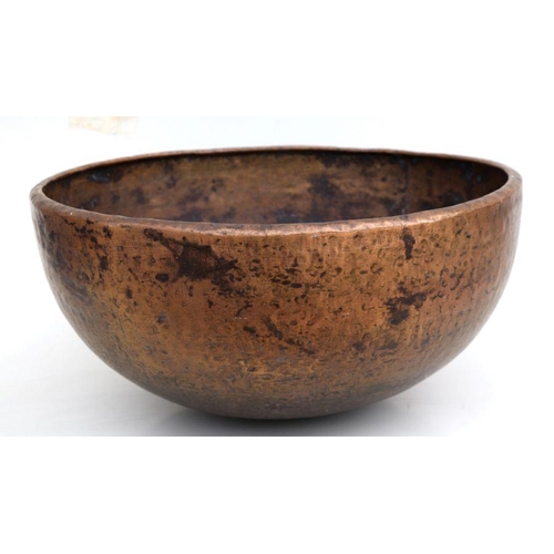 389 - A large hand beaten brass bowl, 55cms diameter.