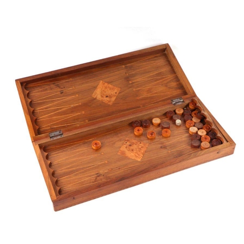 391 - A specimen wood backgammon, chess and other games board, 55cms wide.