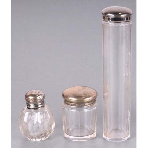 440 - A set of six George V silver topped glass cosmetics jars, initialled, London 1919 and other similar.