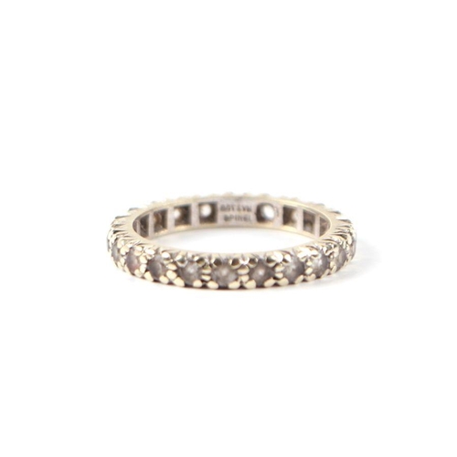 487 - A 9ct white gold and spinel eternity ring, approx UK size 'M'.