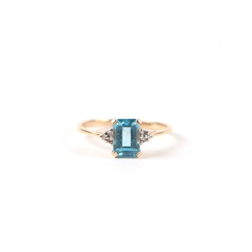 503 - A 9ct gold dress ring set with a rectangular blue stone and diamond set shoulders, approx UK size 'L... 