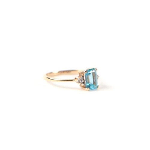 503 - A 9ct gold dress ring set with a rectangular blue stone and diamond set shoulders, approx UK size 'L... 