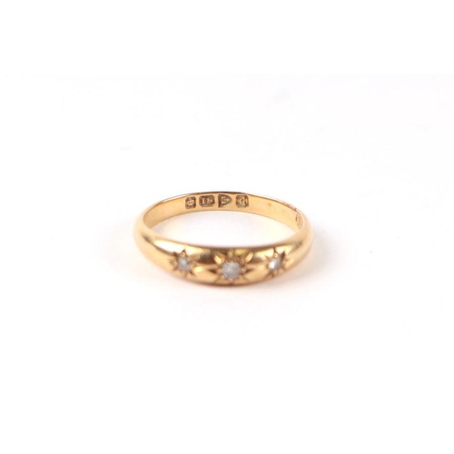 505 - An 18ct gold threes stone diamond gypsy ring, approx UK size 'O', 3.2g.