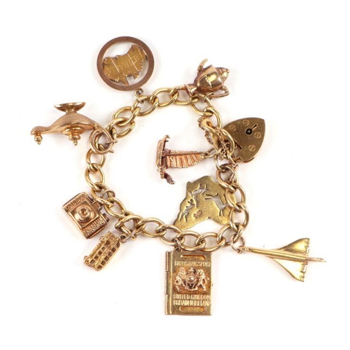 518 - A 9ct gold padlock charm bracelet with nine charms, 30.8g; together with four loose 9ct gold charms,... 