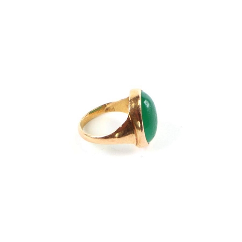 520 - A gentleman's 22ct gold (stamped) green cabochon stone signet ring, approx UK size 'D', 3.7g.