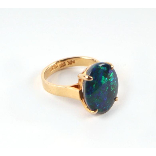 521 - A 14ct gold and black opal cabochon ring, approx UK size 'K', 4.8g.