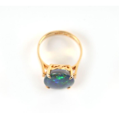 521 - A 14ct gold and black opal cabochon ring, approx UK size 'K', 4.8g.