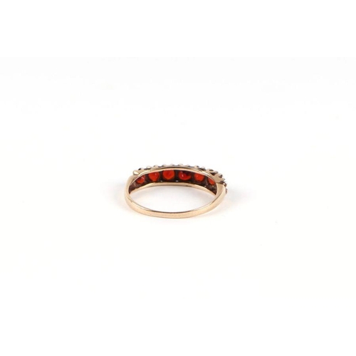 531 - A 9ct gold and garnet half hoop ring, approx UK size 'L', 1.3g.