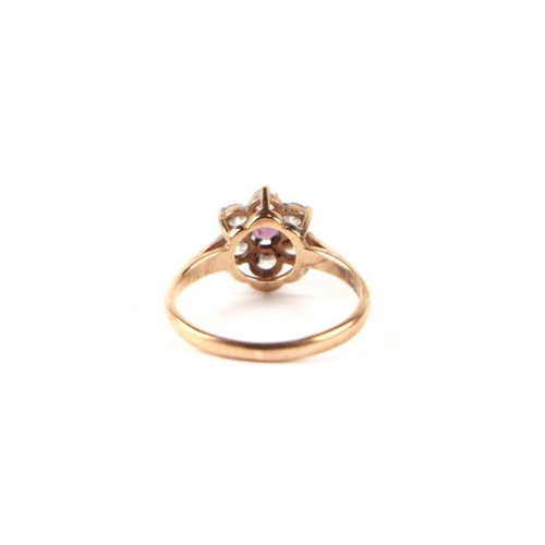 534 - A 9ct gold white and pink stone flower head ring, approx UK size 'N', 1.8g.