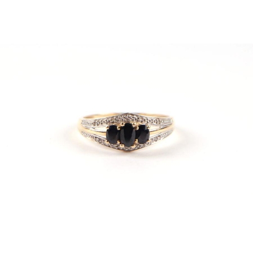 537 - A 9ct gold three-stone sapphire ring, approx UK size 'P', 1.9g.