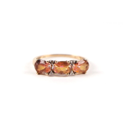 548 - A 9ct gold three pink stone and diamond half hoop ring, approx UK size 'P', 1.9g.