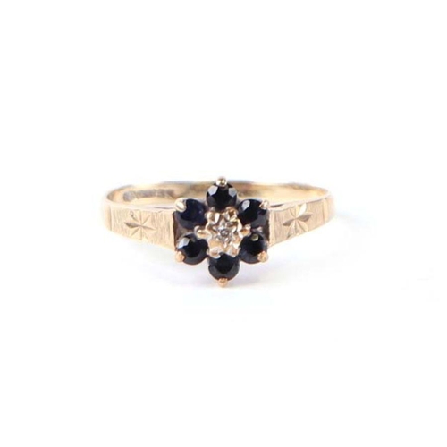 557 - A 9ct gold sapphire and diamond cluster ring, approx UK size 'K', 1.3g.