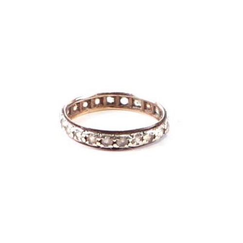 562 - A 9ct gold eternity ring set with white stones, approx UK size 'O', 1.7g.