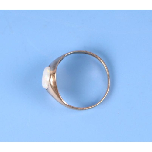 565 - A 9ct gold ring set with an oval opal cabochon, approx UK size 'I', 1.2g.