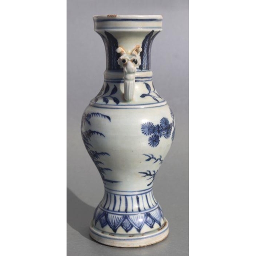 583 - A Chinese blue & white baluster vase with elephant handles and foliate decoration, 23cms high.