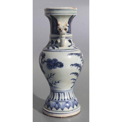 583 - A Chinese blue & white baluster vase with elephant handles and foliate decoration, 23cms high.