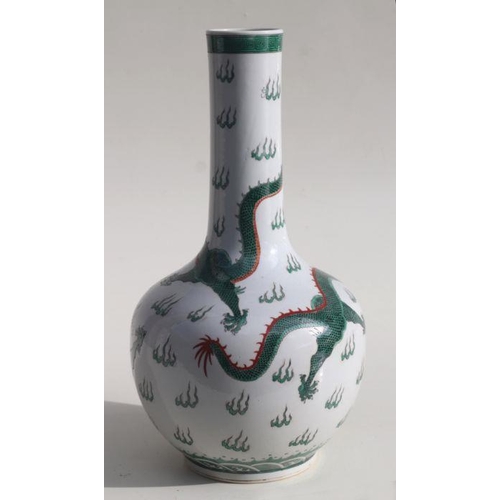 586 - A Chinese famille verte bottle vase decorated with dragons chasing a flaming pearl, blue character m... 