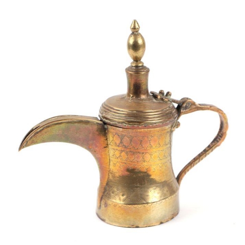 587 - A Turkish / Islamic brass dallah coffee pot, 22cms high.