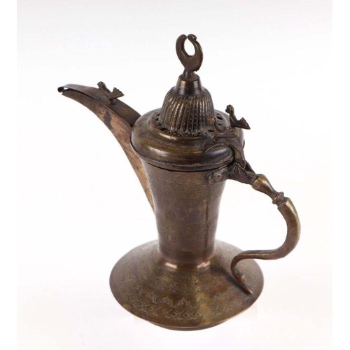 597 - A Turkish / Islamic brass dallah coffee pot, 24cms high.