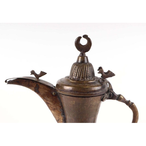 597 - A Turkish / Islamic brass dallah coffee pot, 24cms high.