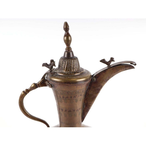 598 - A Turkish / Islamic brass dallah coffee pot, 26cms high.