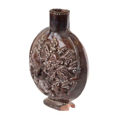 631 - A Chinese brown monochrome glazed moon flask with embossed dragon panels, 12cms diameter.Condition R... 