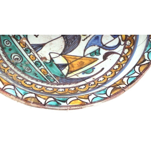 633 - An Iznik pattern footed bowl decorated with a stylised ship (a/f), 29.5cms diameter.