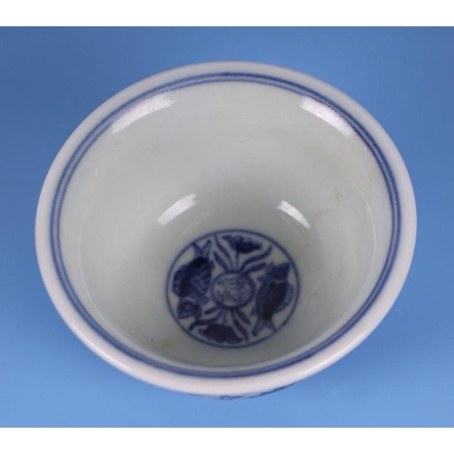 643 - A Chinese blue & white footed bowl decorated with scrolling flowering foliage, 9.5cms diameter.