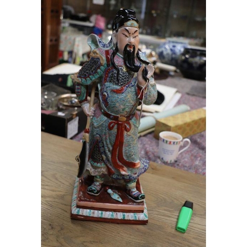 673 - A Chinese figure of Guan Gong with impressed seal mark to the underside, 44cms high.Condition Report... 