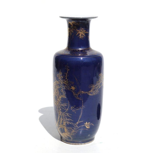 674 - A Chinese rouleau vase with gilt decoration on a blue ground, on a hardwood stand, 20cms high.