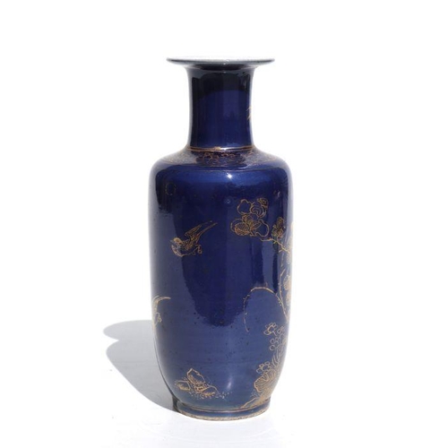 674 - A Chinese rouleau vase with gilt decoration on a blue ground, on a hardwood stand, 20cms high.