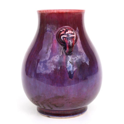 683 - A Chinese flambe glaze baluster two-handled vase, 20cms high.