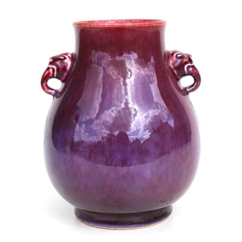 683 - A Chinese flambe glaze baluster two-handled vase, 20cms high.