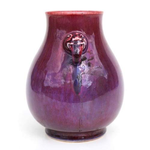 683 - A Chinese flambe glaze baluster two-handled vase, 20cms high.