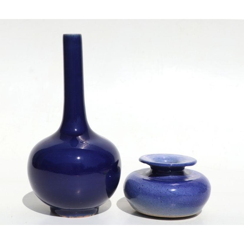 684 - A Chinese blue monochrome bottle vase, 22cms high; together with a blue glazed vase of compressed ci... 